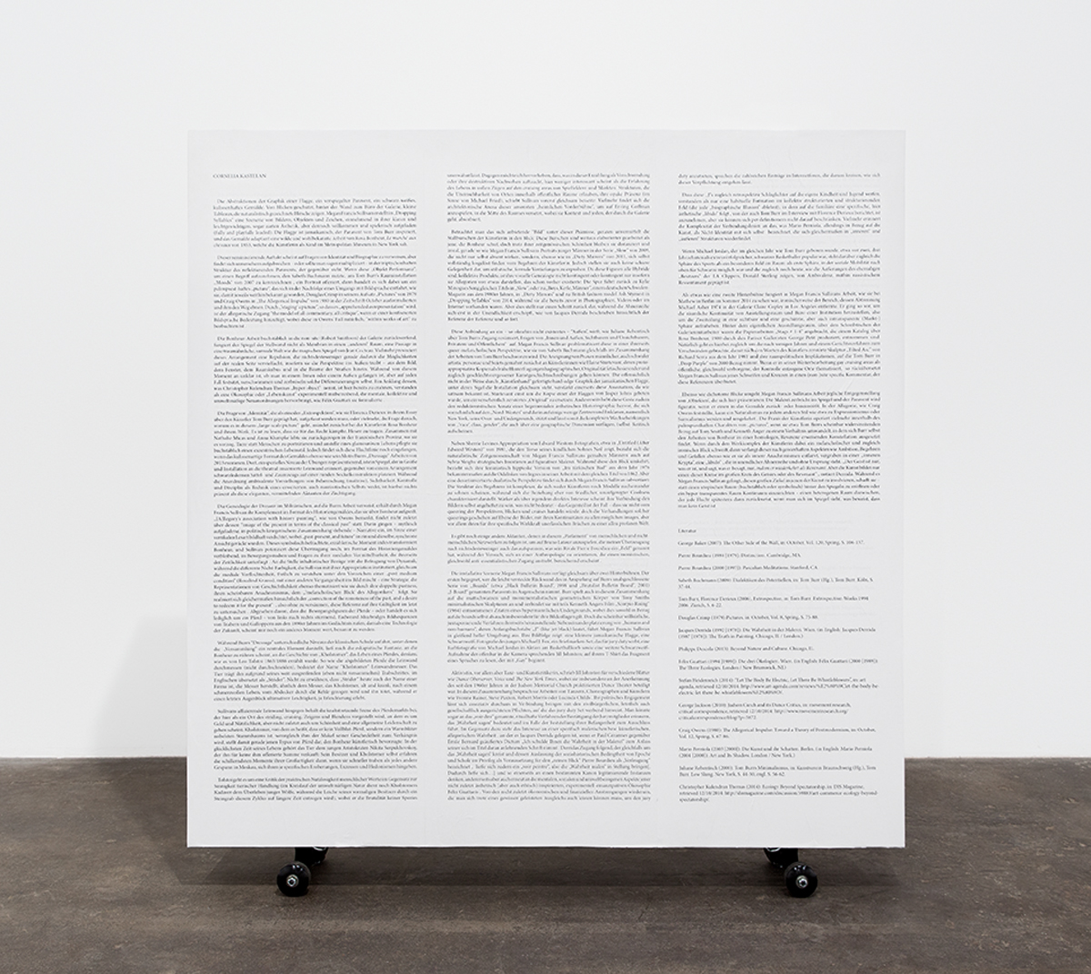 Side A: Text in lieu of an object, 2014. Plywood, pine, printed text, flashe, wheels. 51 x 48 x 6 inches.